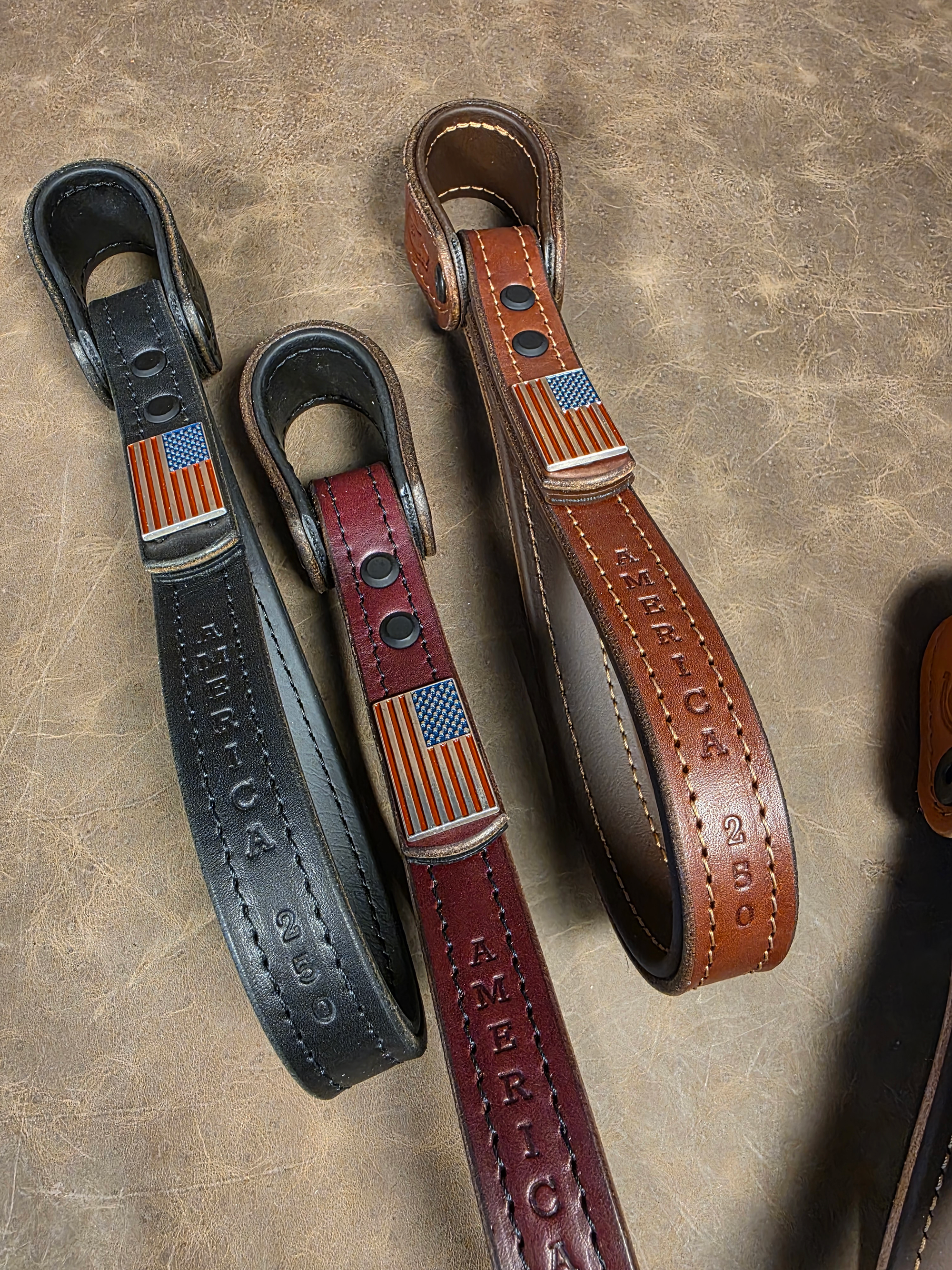 Three limited edition American flag grab handles lay together on a leather background